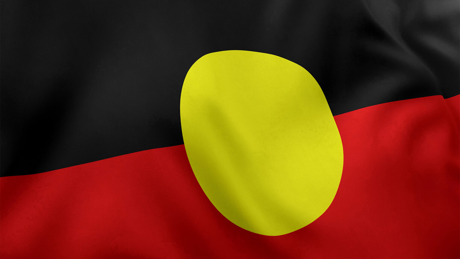 Aboriginal Flag. Equal halves of black (top) and red (bottom), with a yellow circle in the centre.