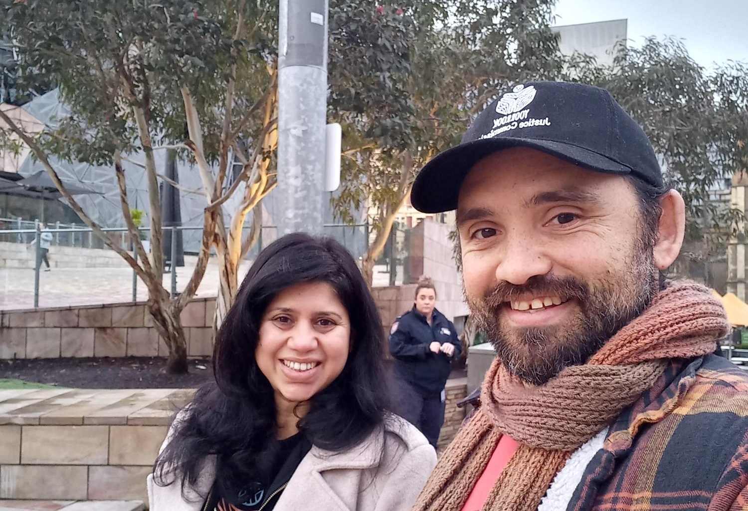 Truth Receiver Stephen Thorpe with Yoorrook colleague Chathuri Wickramasinghe at the NAIDOC flag raising at federation square