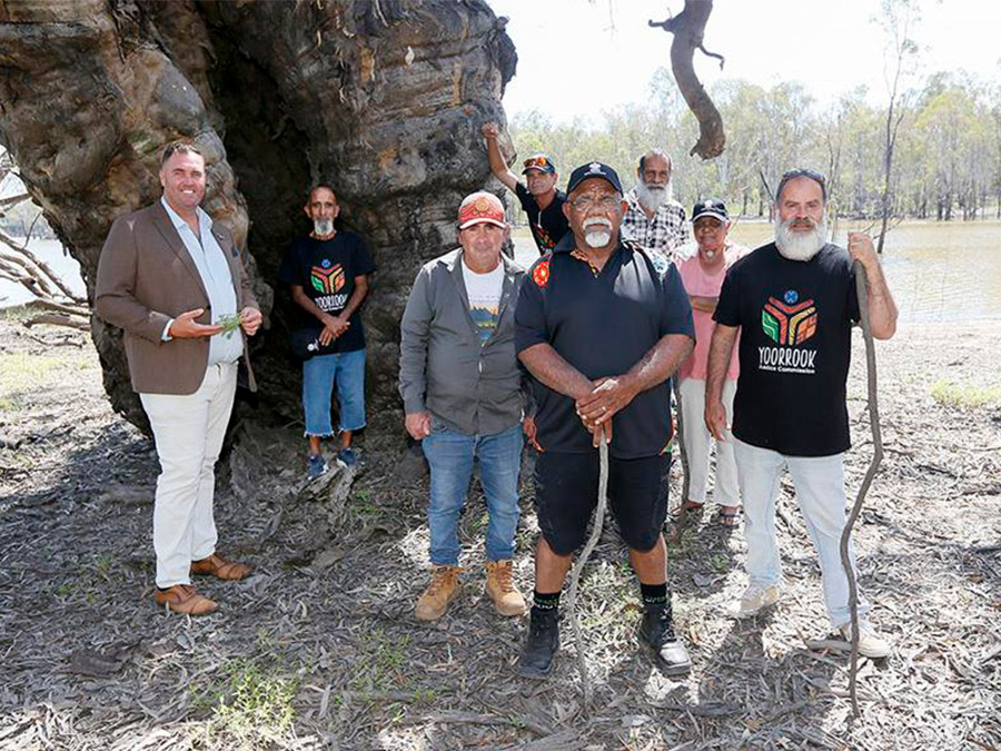 Commissioner Lovett with Tati Tati Traditional Owners in-front of a giant tree and lake