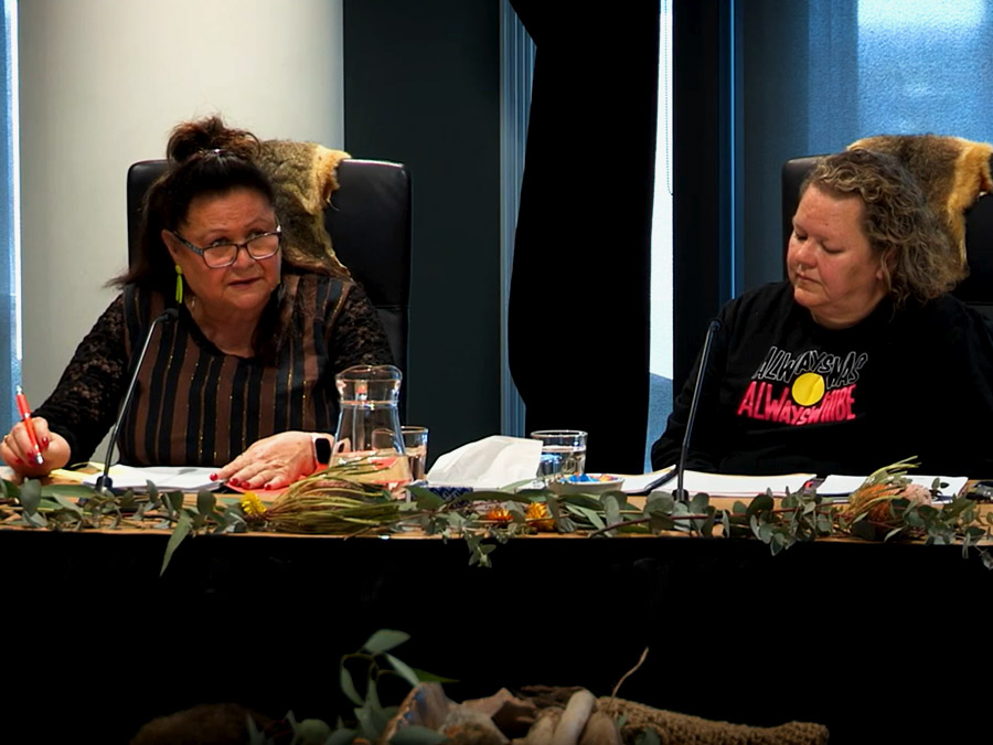 Aunty Jill Gallagher and Sheree Lowe discuss the health system in the Yoorrook hearing room.