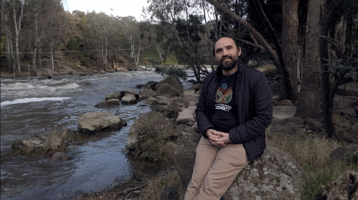 Truth receiver Stephen Thorpe sitting on a rock next to  the Birrarung (Yarra river) at Dights Falls